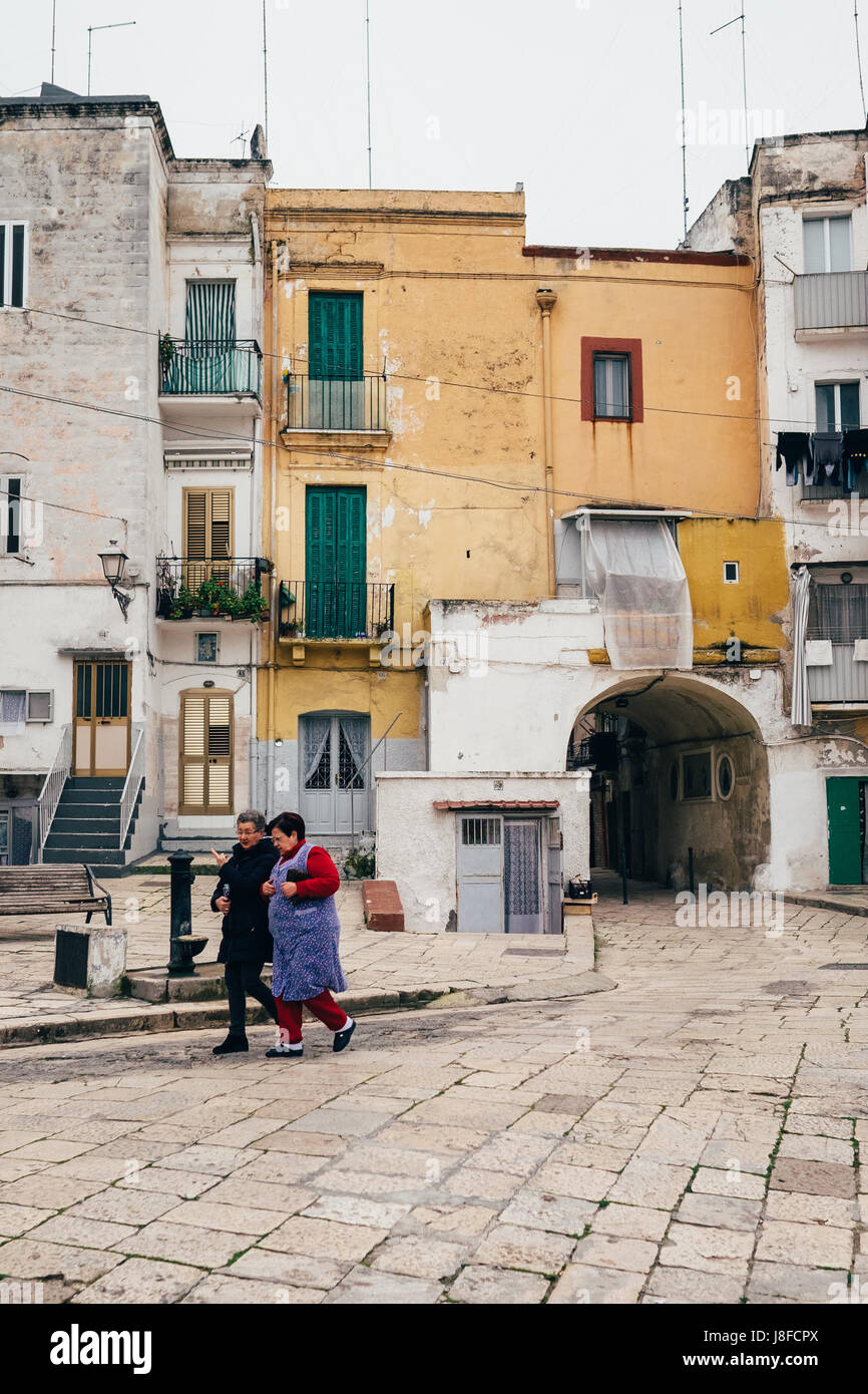 Two women stroll past typical houses in Bari Vecchia, Puglia, Italy ...