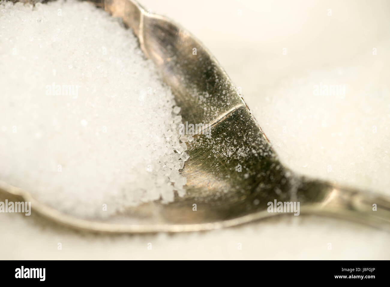 closeup to white sugar in spoon Stock Photo Alamy