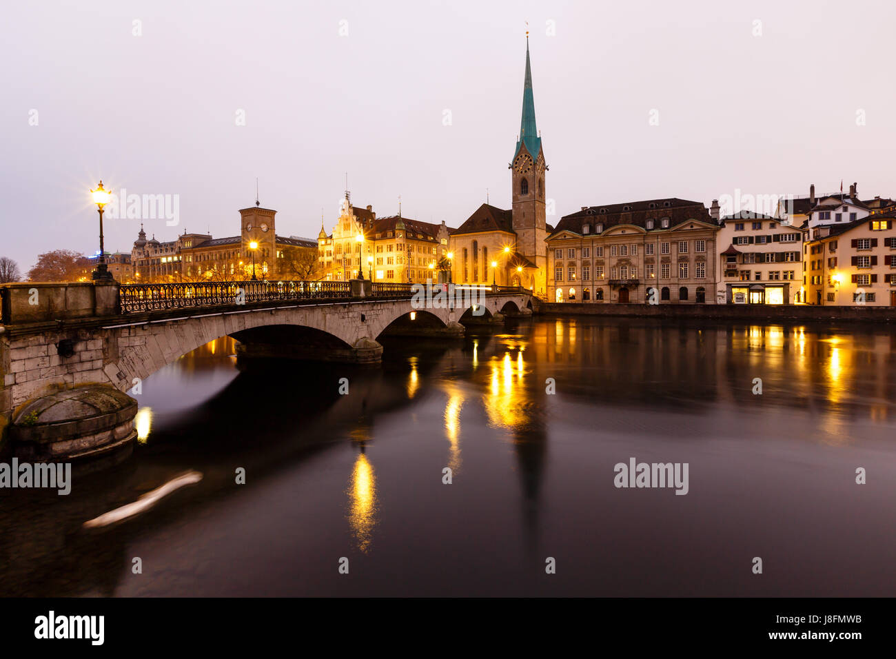 View of Zurich and Old City Center Reflecting in the river Limmat at Morning, Switzerland Stock Photo