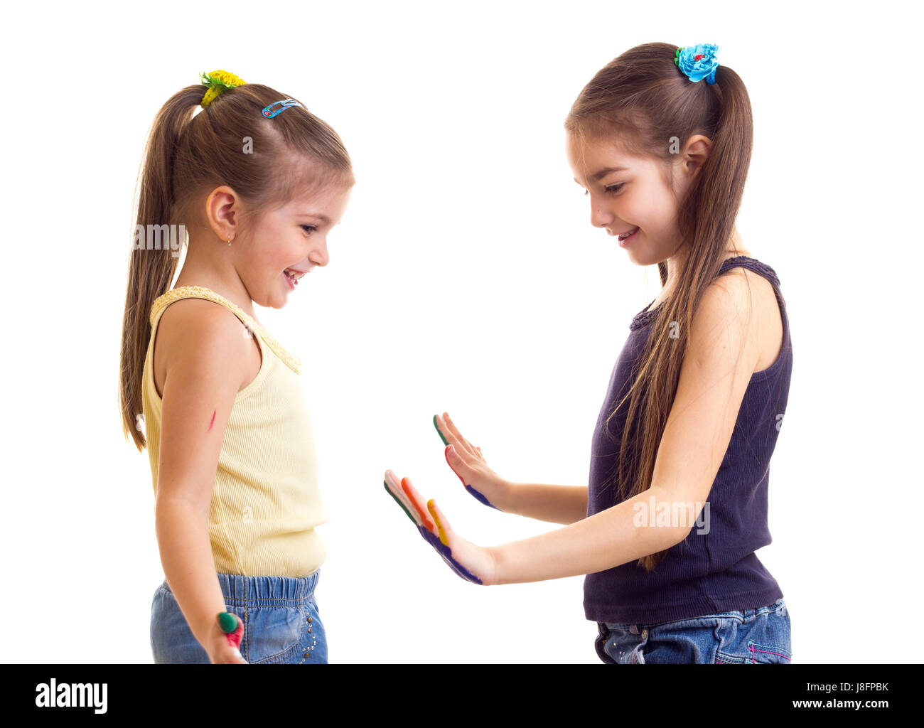 Two Little Cute Girls In Yellow And Black Shirts With