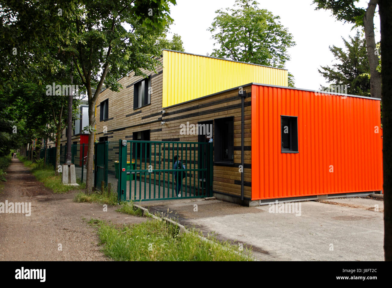 Containerville housing alongside the Allee de fortifications in PAris, France. Cheap temporary housing in cities, made from shipping containers. Stock Photo