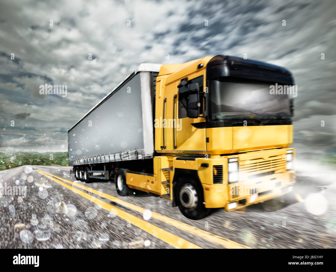 Transporter truck on a highway during storm Stock Photo