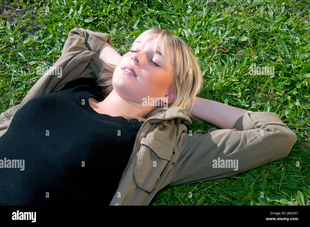 young woman lying on a meadow Stock Photo