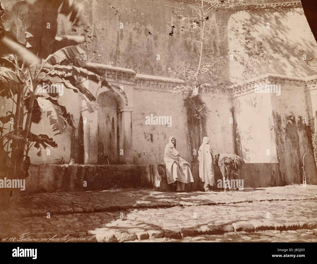 The fountain near the entrance of Jardin d'Essai is a decorative feature within the botanical garden in Algiers, Algeria. It reflects the gardenâ€™s design and cultural significance. Stock Photo