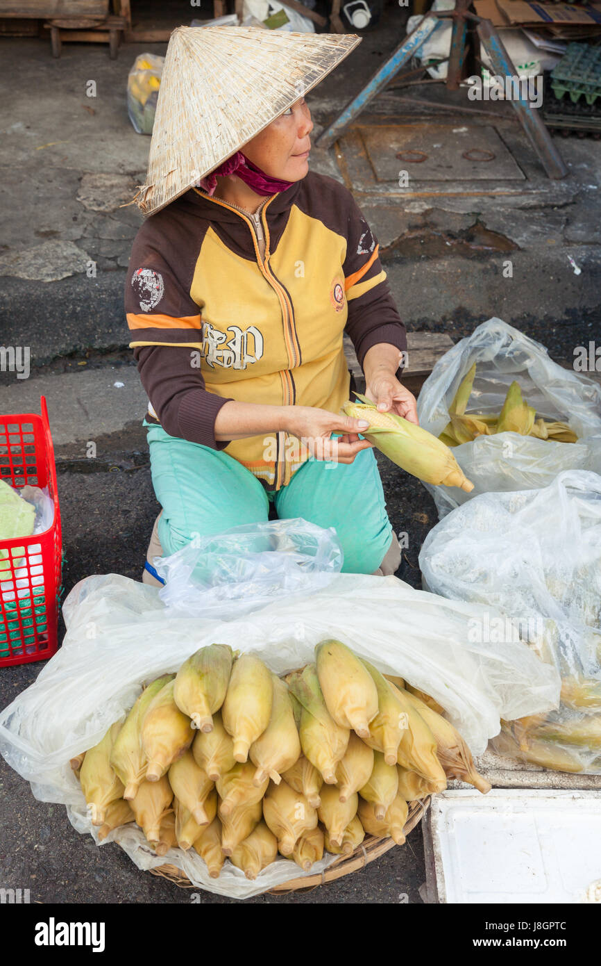 Nha Trang, Vietnam - December 02, 2015: Vietnamese woman is selling corn at the street market, Nha Trang, Vietnam on December 02, 2015. Stock Photo