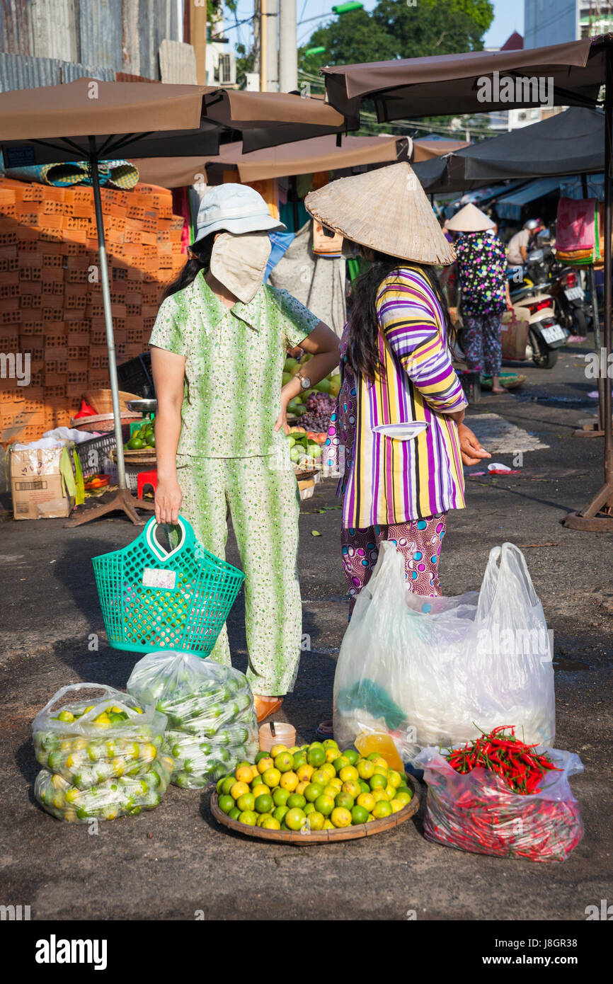 Nha Trang, Vietnam - December 02, 2015: Two vietnamese women are having a conversation at the street market, Nha Trang, Vietnam on December 02, 2015. Stock Photo