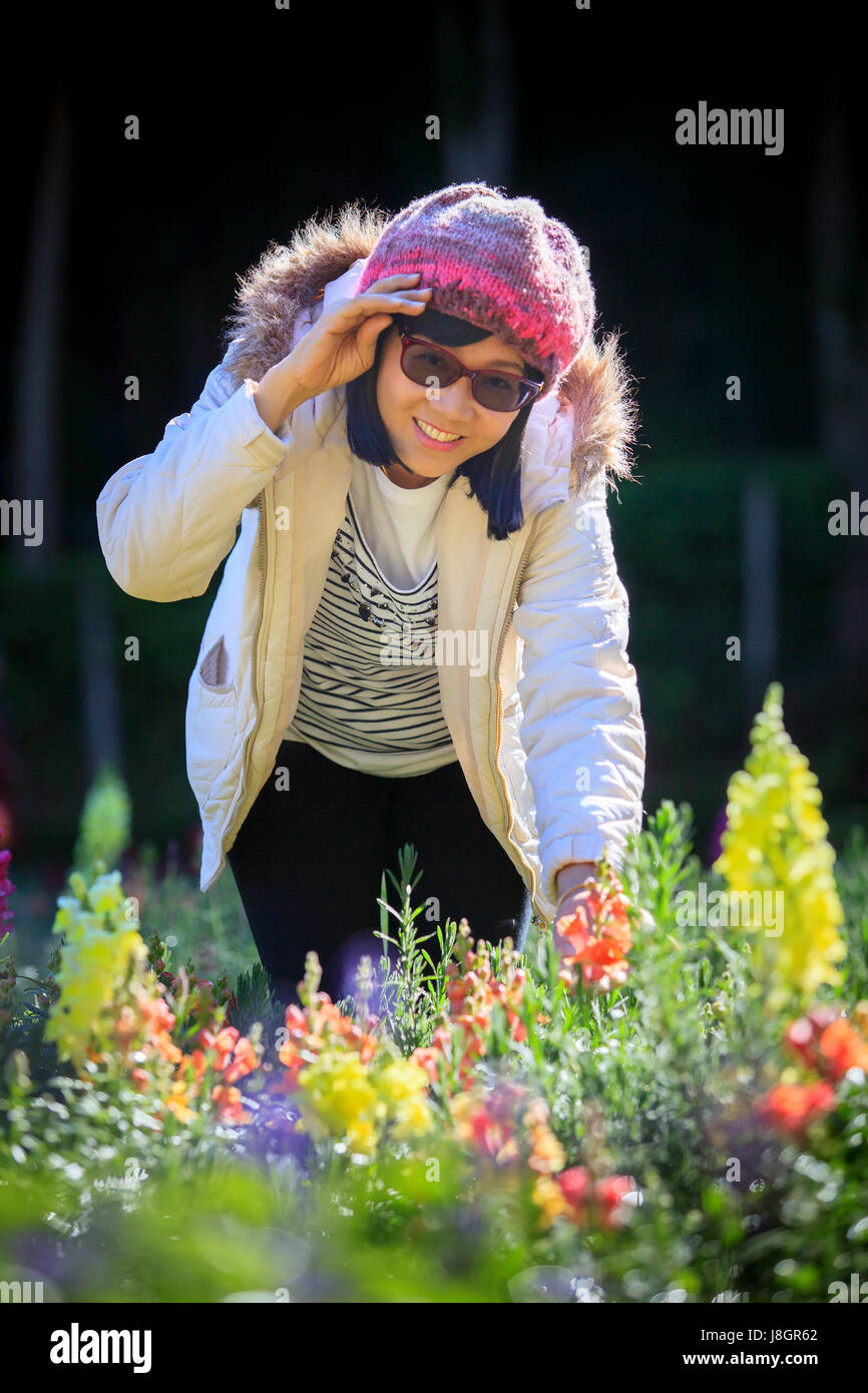 portrait of happiness asian woman with smiling face in blooming flowers garden use for relaxing people in vacation traveling Stock Photo