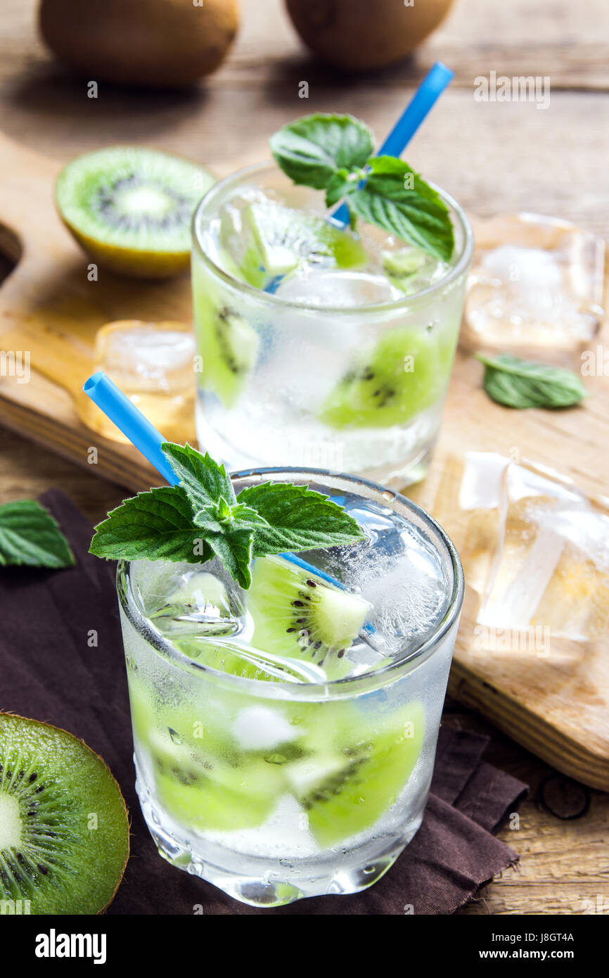 Kiwi drink (cocktail) with mint and ice in glasses close up. Cold summer drink. Stock Photo
