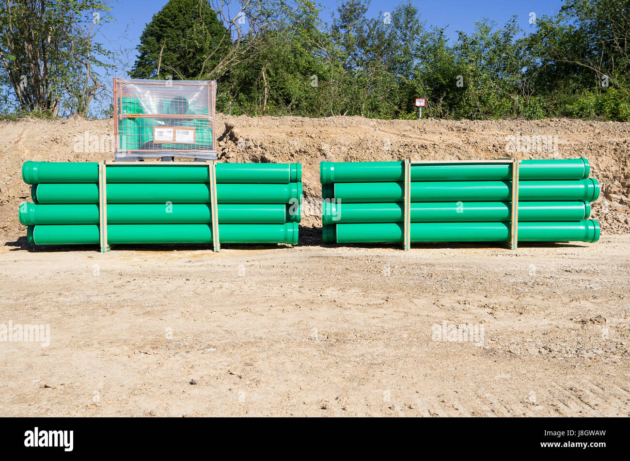 pallets of green sewer pipes at construction site Stock Photo Alamy