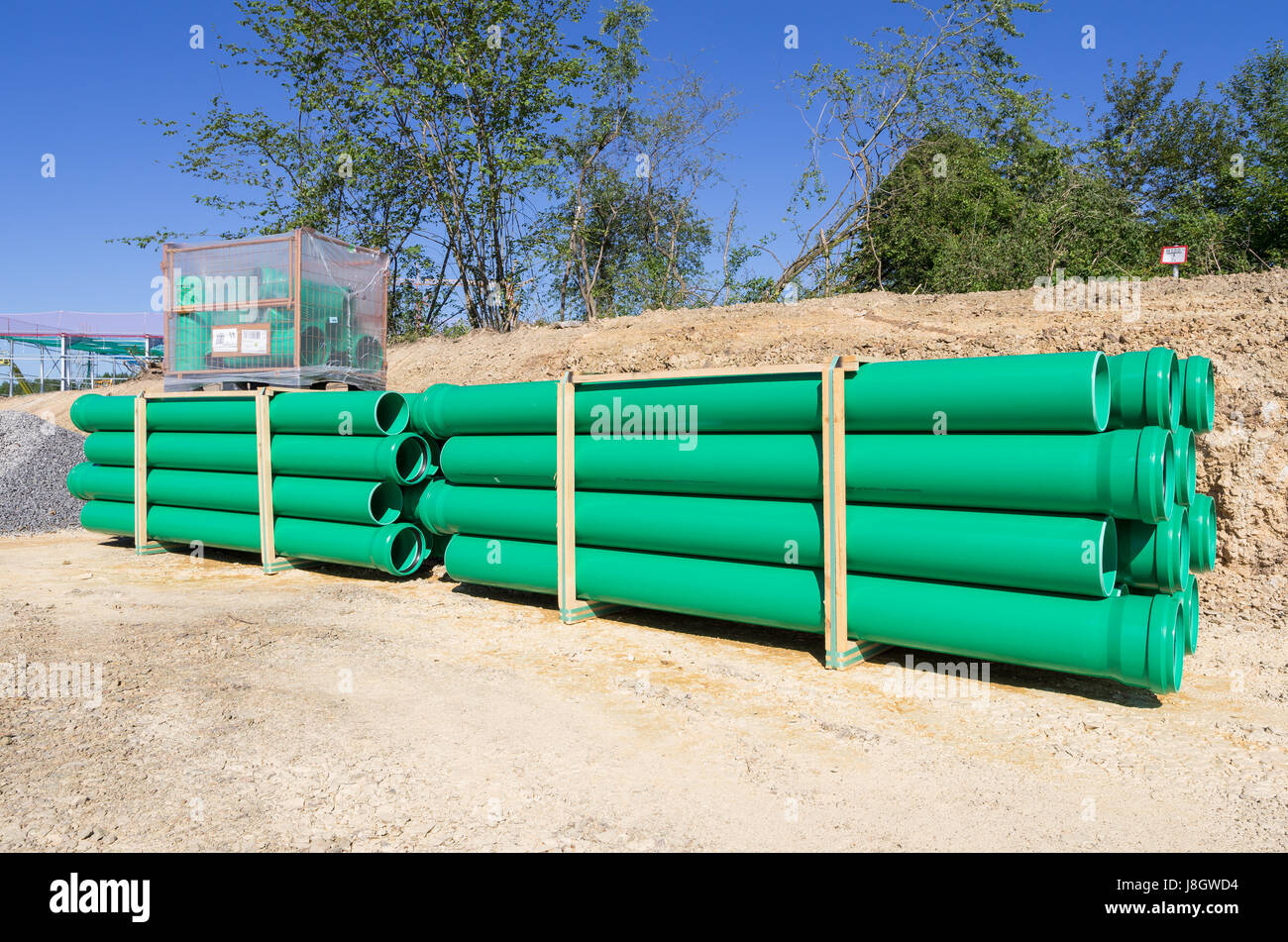 pallets of green sewer pipes at construction site Stock Photo Alamy