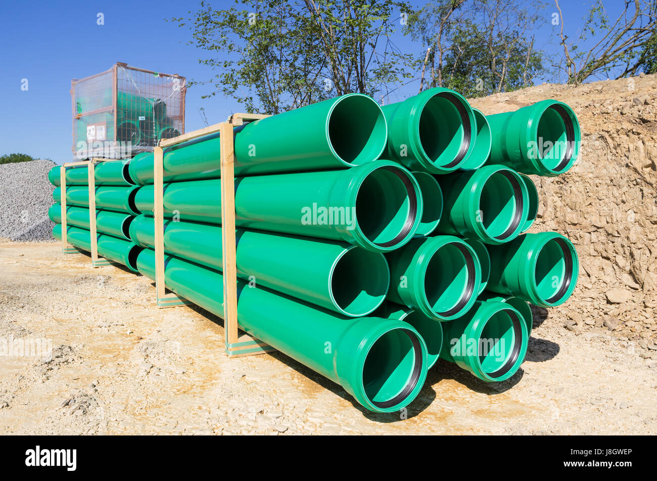 pallets of green sewer pipes at construction site Stock Photo Alamy