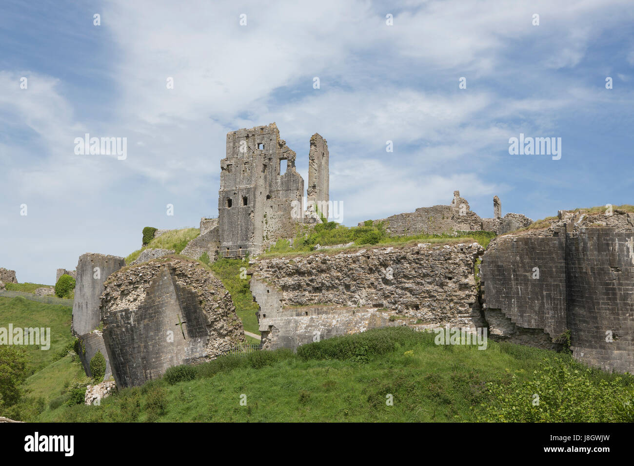 view of the damaged and subsiding outer wall of Corfe castle commanding a good position on a hilltop on the Isle of Purbeck in Dorset. Stock Photo