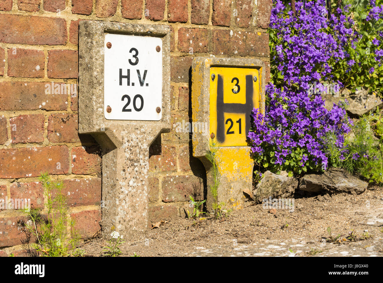 Concrete marker posts for water hydrant and HV in the UK, Stock Photo