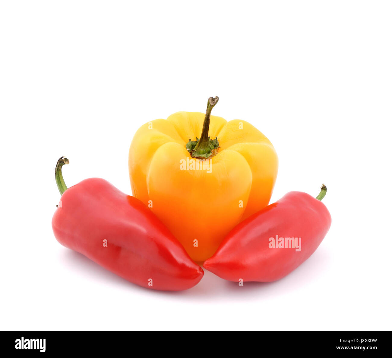 Red and yellow sweet peppers on a white background Stock Photo - Alamy