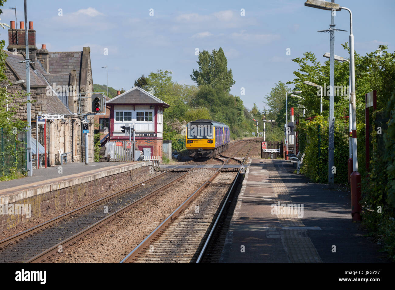 07/05/2017 Parbold Northern  Rail class 142 Pacer trains,  working a Southport - Chestertrain passing the signal box Stock Photo