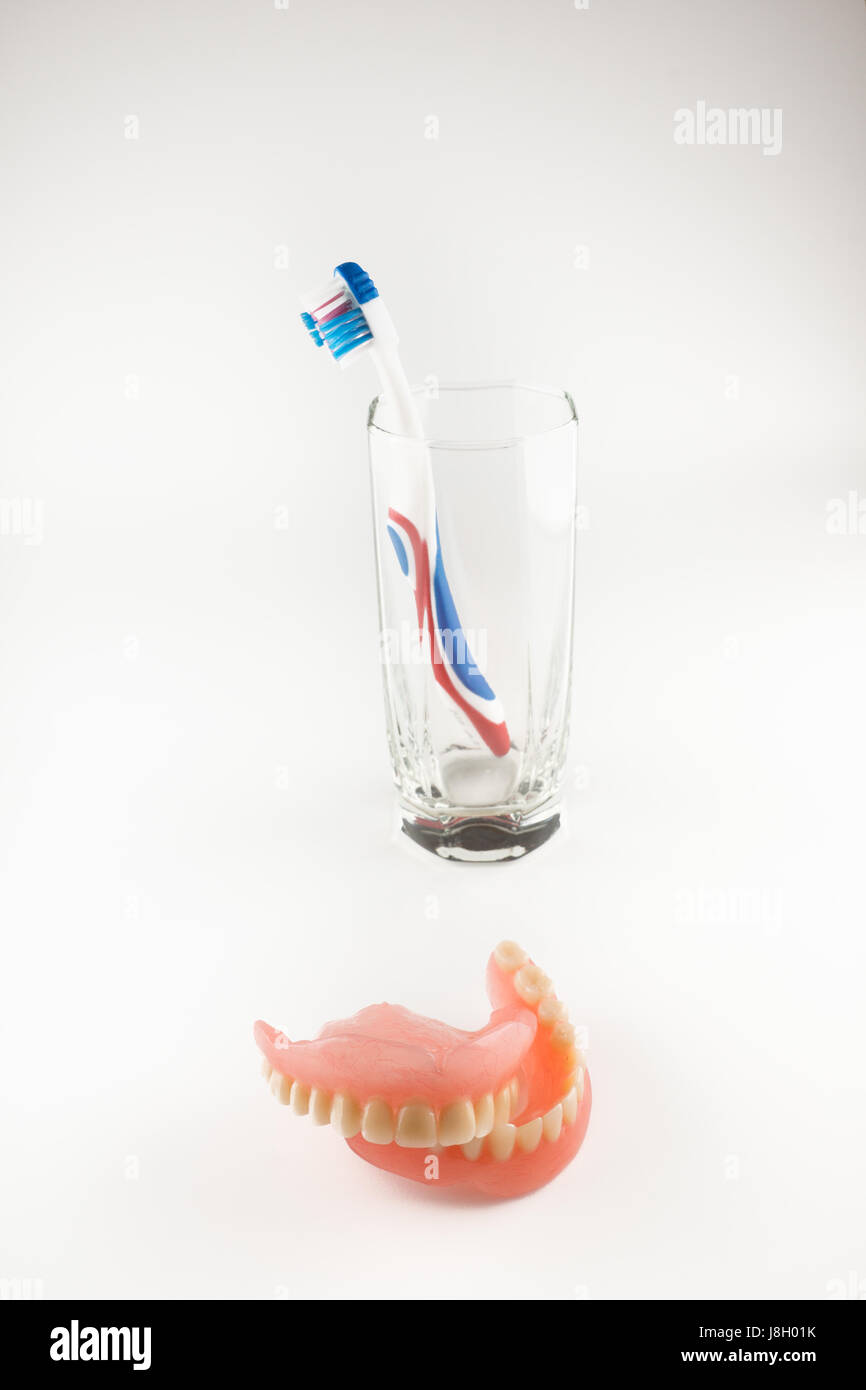 Acrylic removable prosthesis lies on a white background Stock Photo