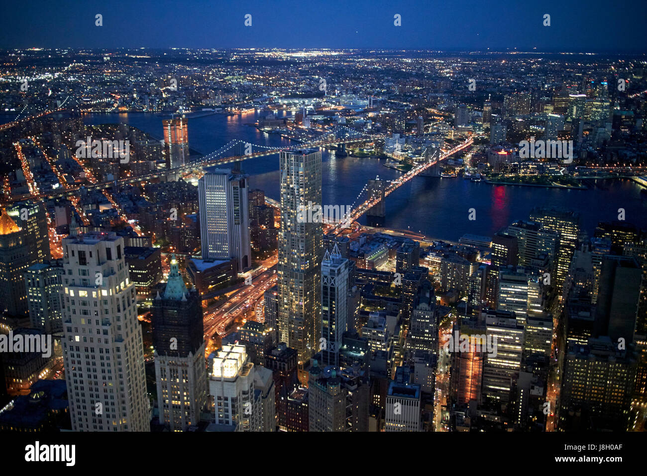 aerial night view of lower manhattan brooklyn bridge manhattan bridge east river and brooklyn New York City USA Stock Photo