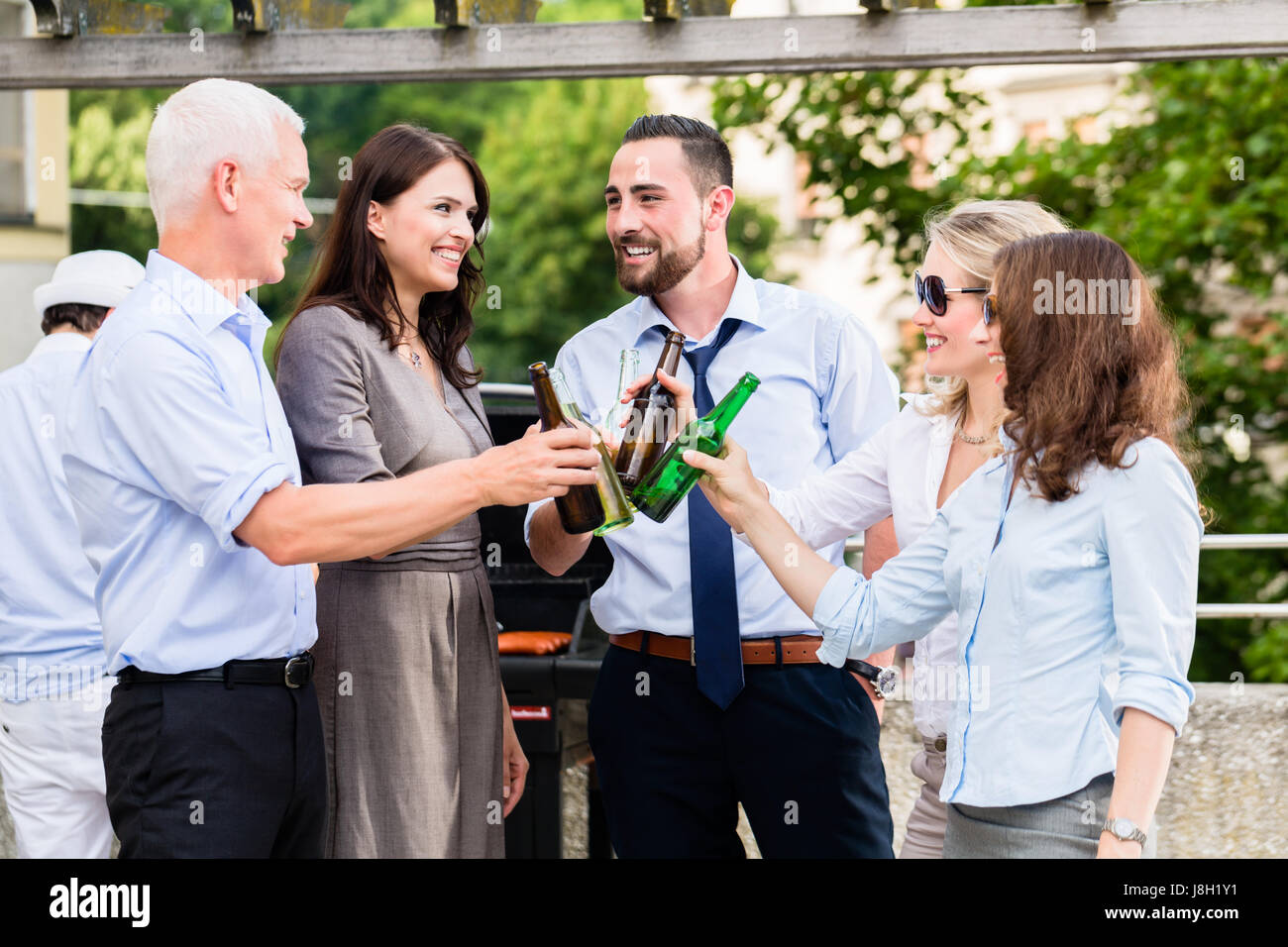 Office colleagues drinking beer after work Stock Photo
