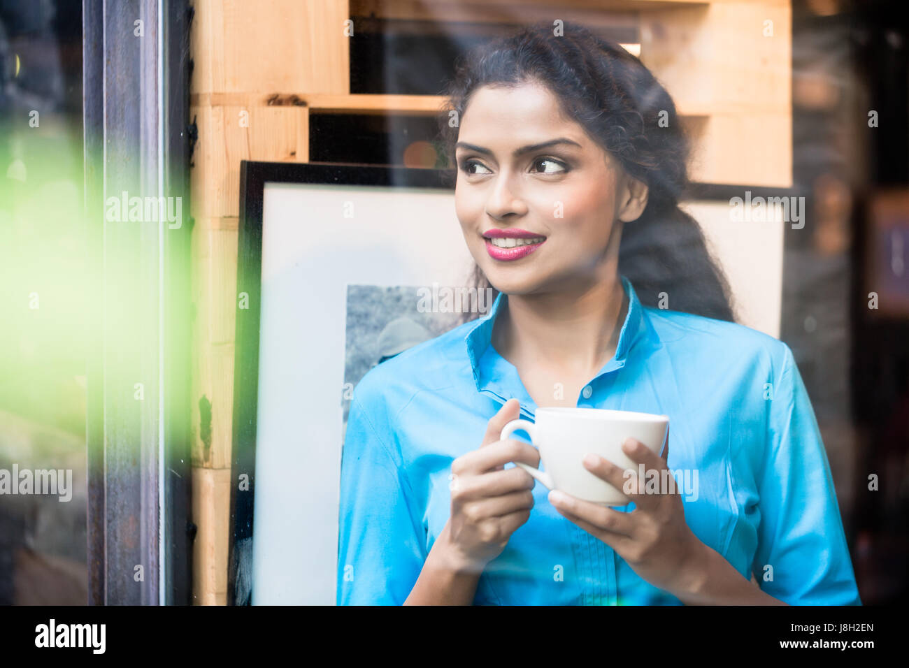 Indian woman with coffee mug Stock Photo
