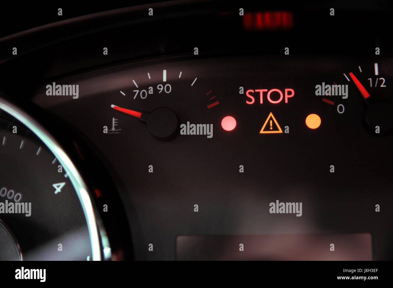 Warning triangle light and 'stop' ignite on dashboard Stock Photo