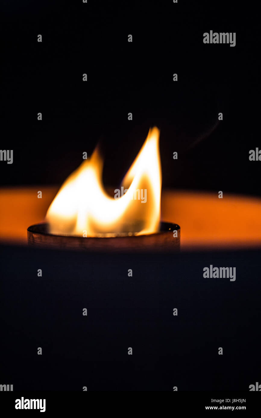 A candle flickering in the dark Stock Photo Alamy