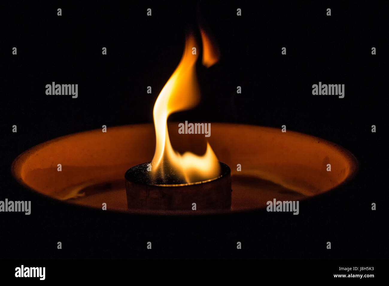 A candle flickering in the dark Stock Photo Alamy