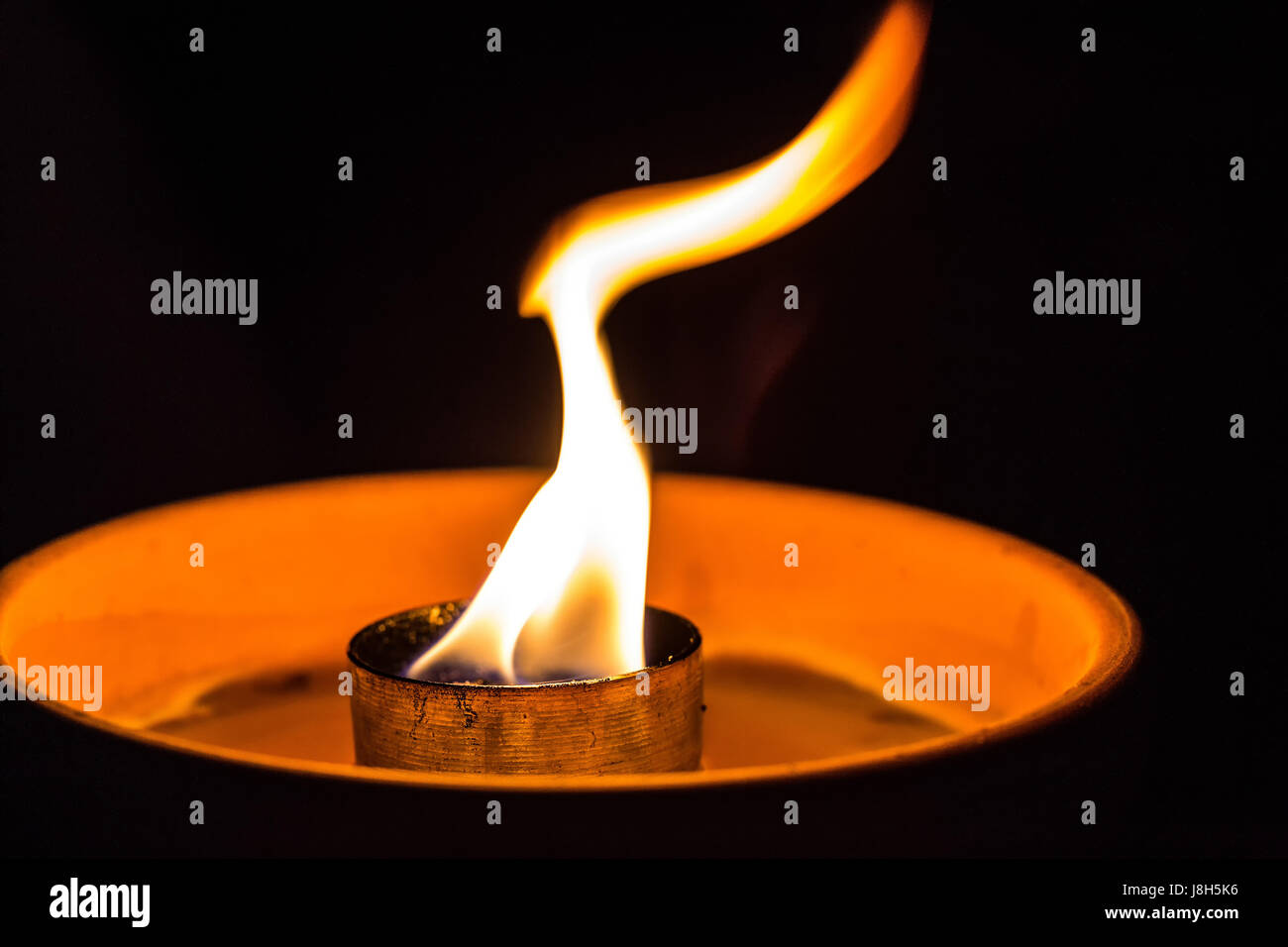 A candle flickering in the dark Stock Photo Alamy