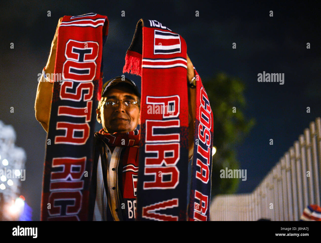A Costa Rica fan holds up team scarfs outside the country's national stadium in San José. Stock Photo