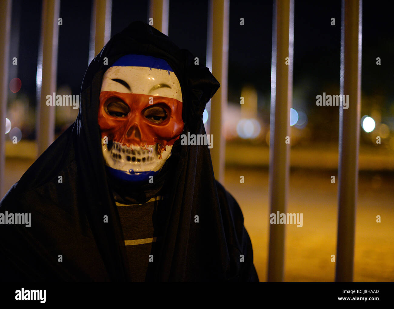 A Costa Rica fan wears a mask outside of the country's national stadium. Stock Photo