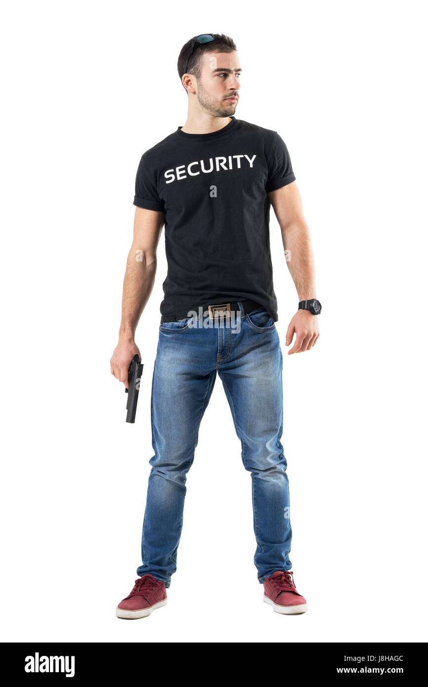 Confident macho plain clothes cop with gun looking away cautiously