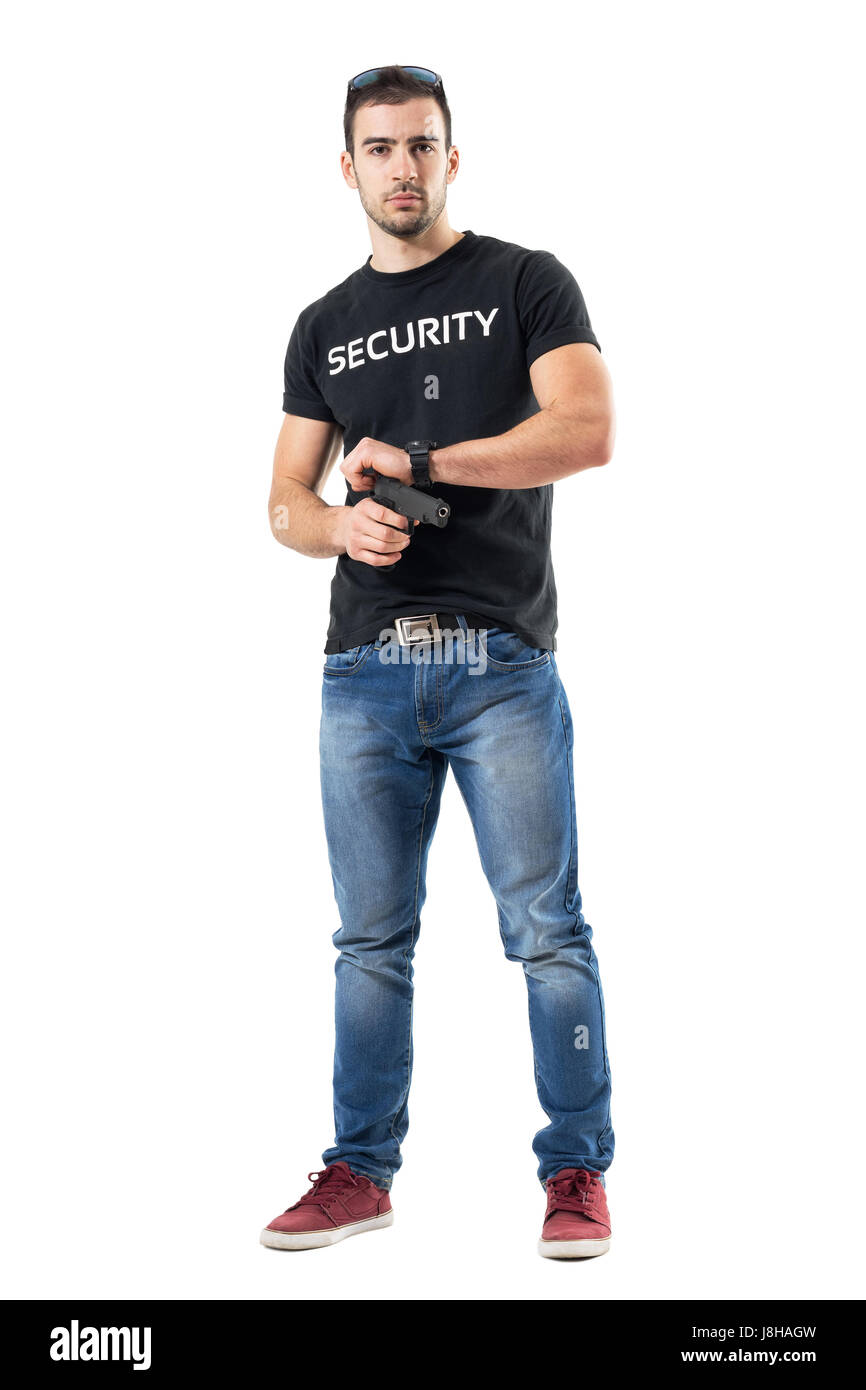 Undercover policeman in plain clothes cocking gun looking at camera. Full body length portrait isolated on white studio background. Stock Photo