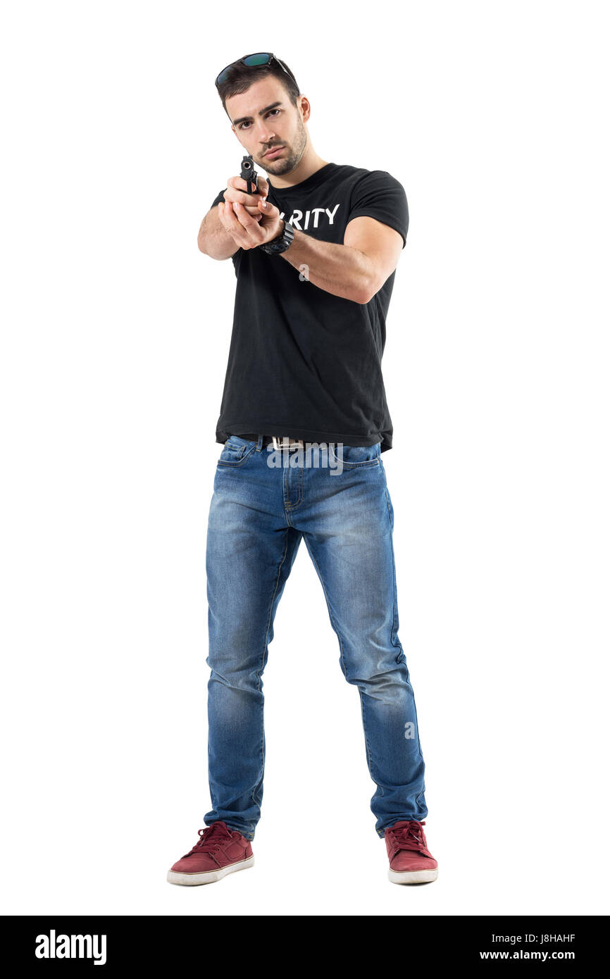 Plain clothes undercover cop aiming gun with both hands at viewer. Full body length portrait isolated on white studio background. Stock Photo