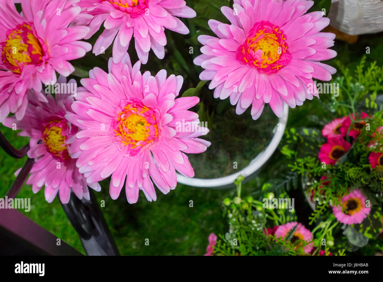 Pink Gerbera fake flower and floral background. The fabric flowers bouquet. Colorful of decoration artificial flower Stock Photo
