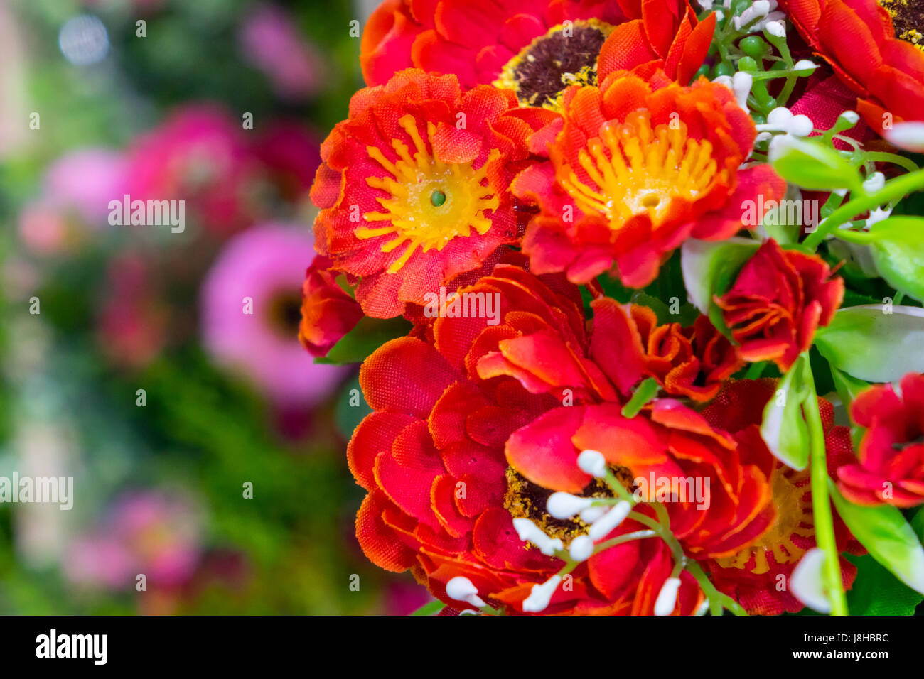 fake flower and floral background.  The fabric flowers bouquet. Colorful of decoration artificial flower Stock Photo