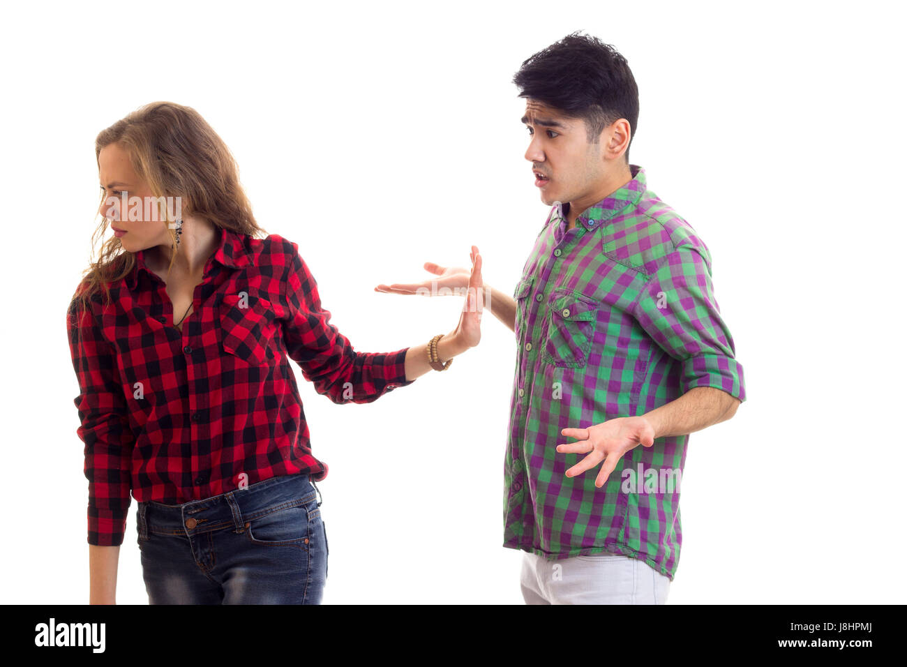 Young couple in plaid shirts arguing  Stock Photo