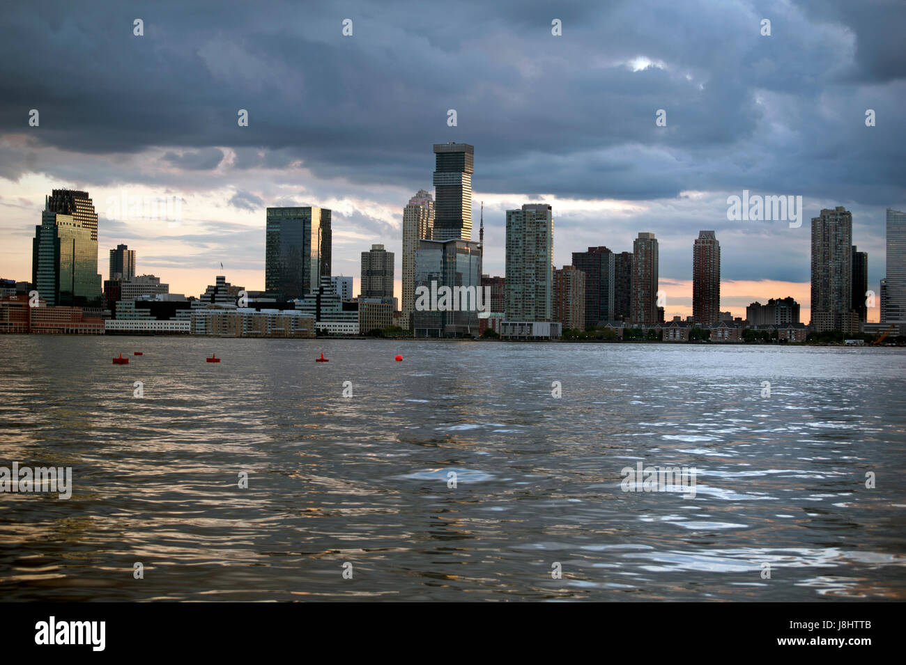 Jersey City as seen at sunset from the New York City side of the Hudson River. May 27, 2017 Stock Photo