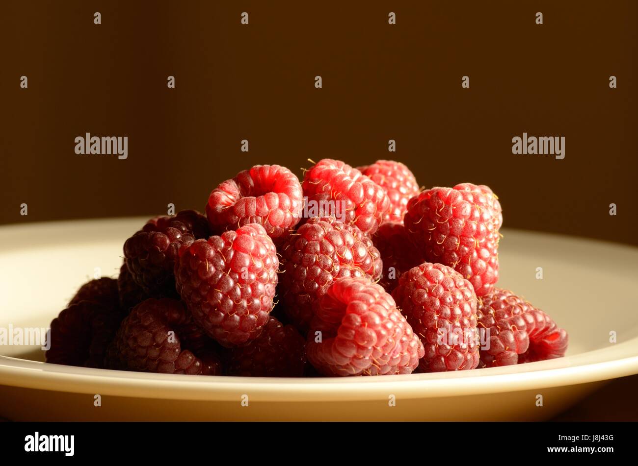 A Dish of Raspberries Stock Photo