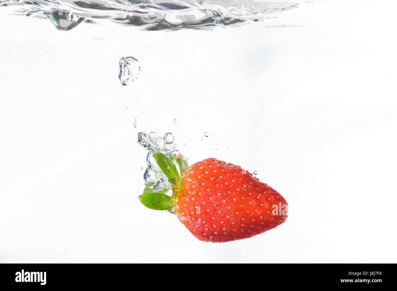 stawberry falling in the water Stock Photo