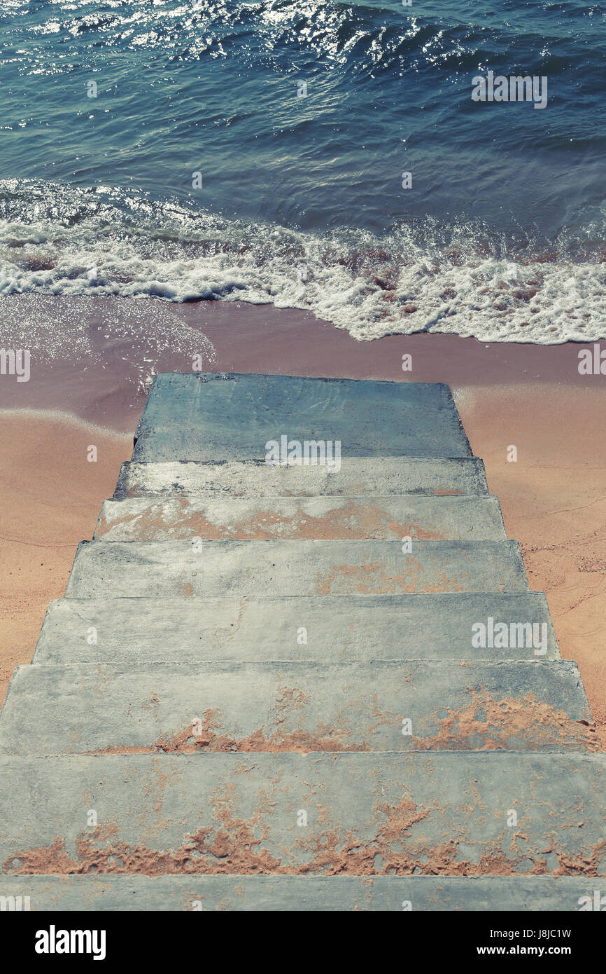 staircase cement steps down to the beach,concept of travel and relaxation,Vintage style decoration photo. Stock Photo