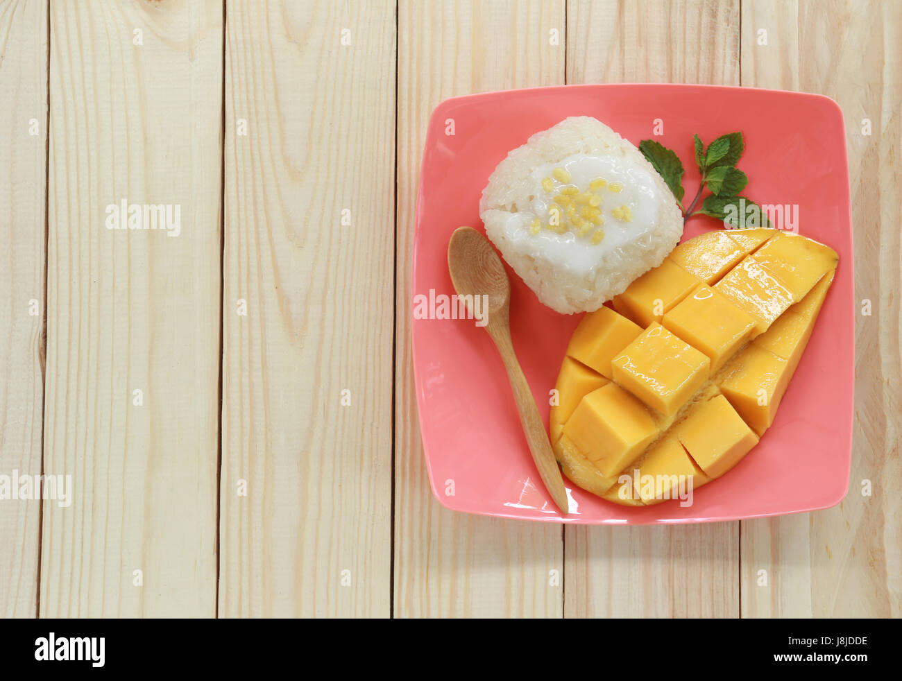 mango and sticky rice on wood background is popular traditional dessert of Thailand. Stock Photo