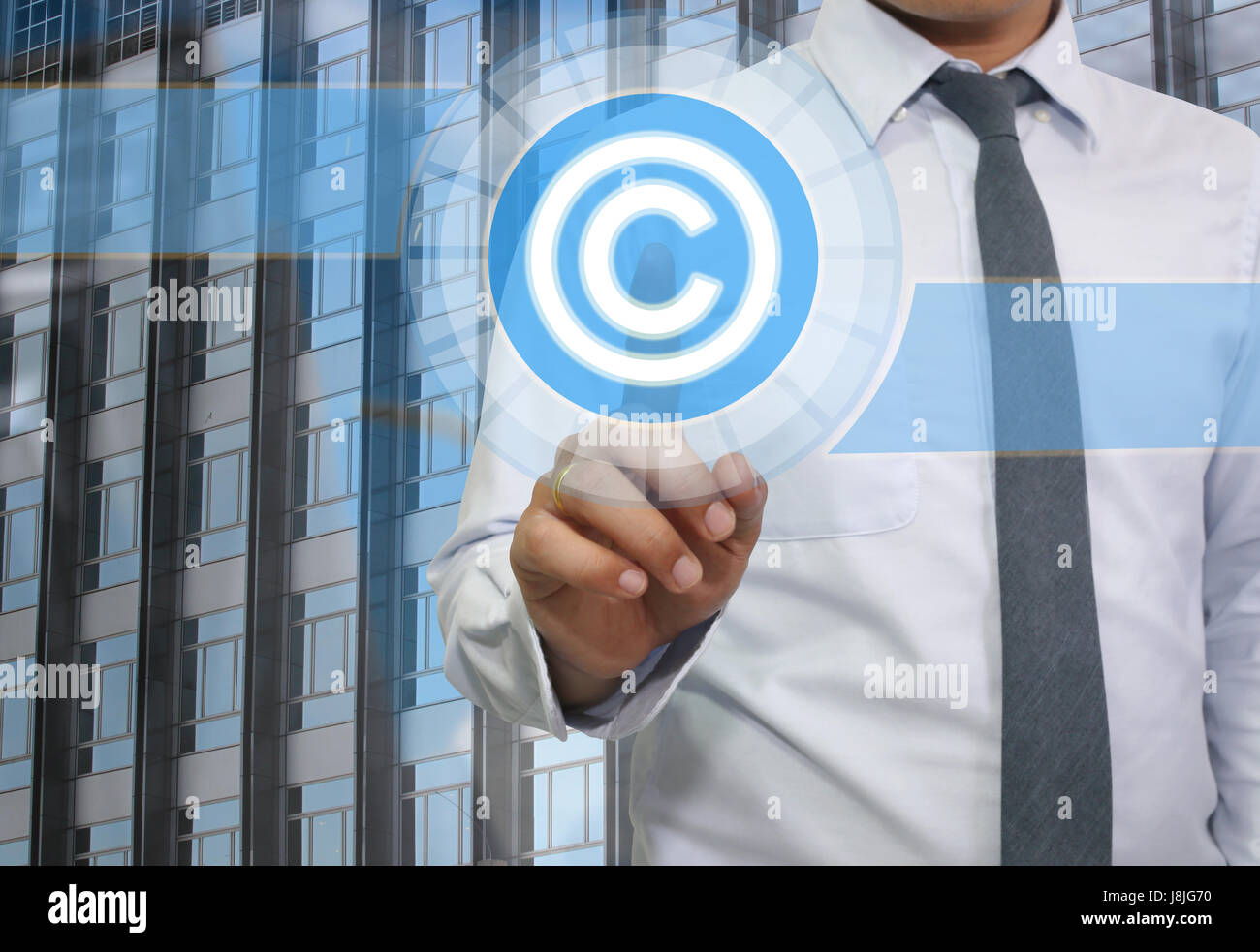 Finger of young businessman point to the blue Copyrighted icon for design business concept. Stock Photo