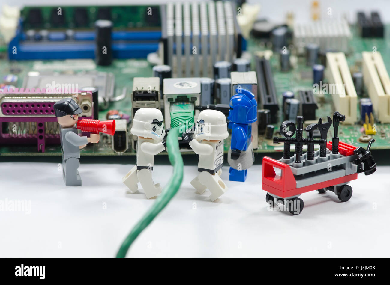 lego storm troopers minifigures plug in internet cable to port on computer  mainboard Stock Photo - Alamy