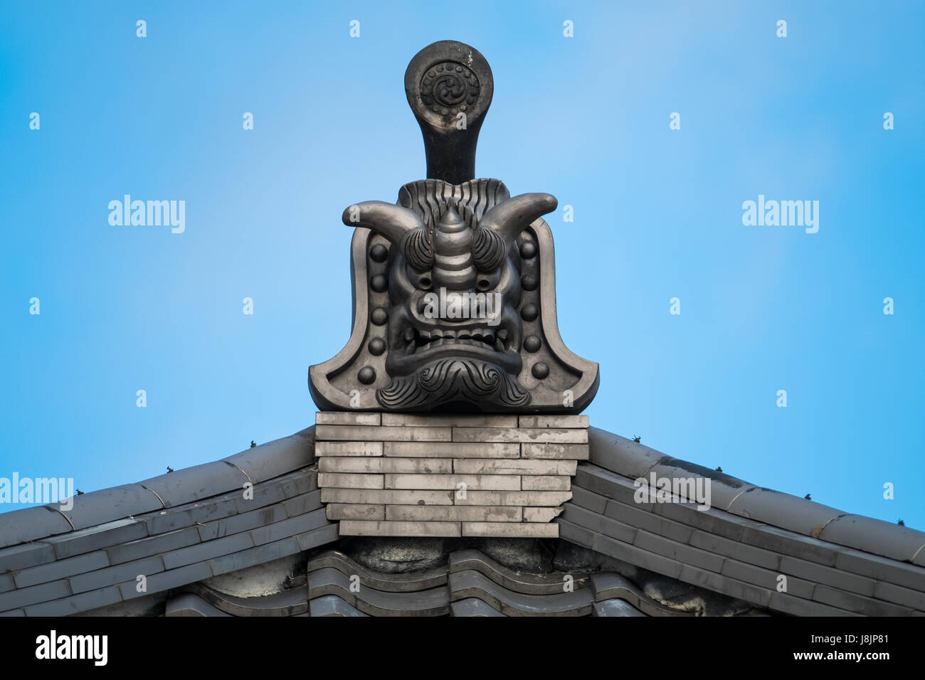 Traditional Japanese architecture and rooftop gargoyles. Stock Photo