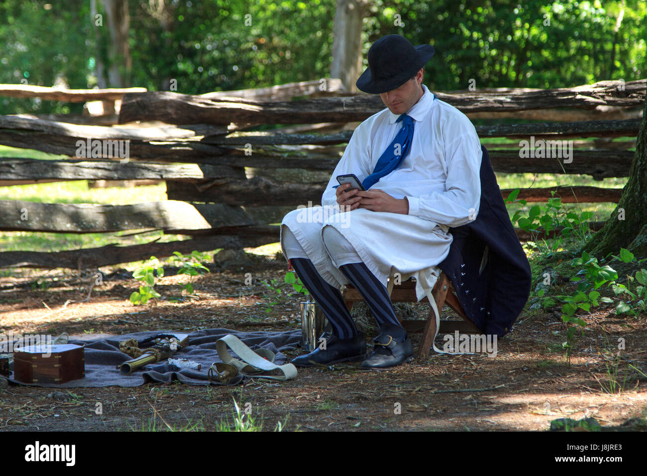 Man checking smart phone in us civil war naval costume memorial day bennett place durham north carolina Stock Photo