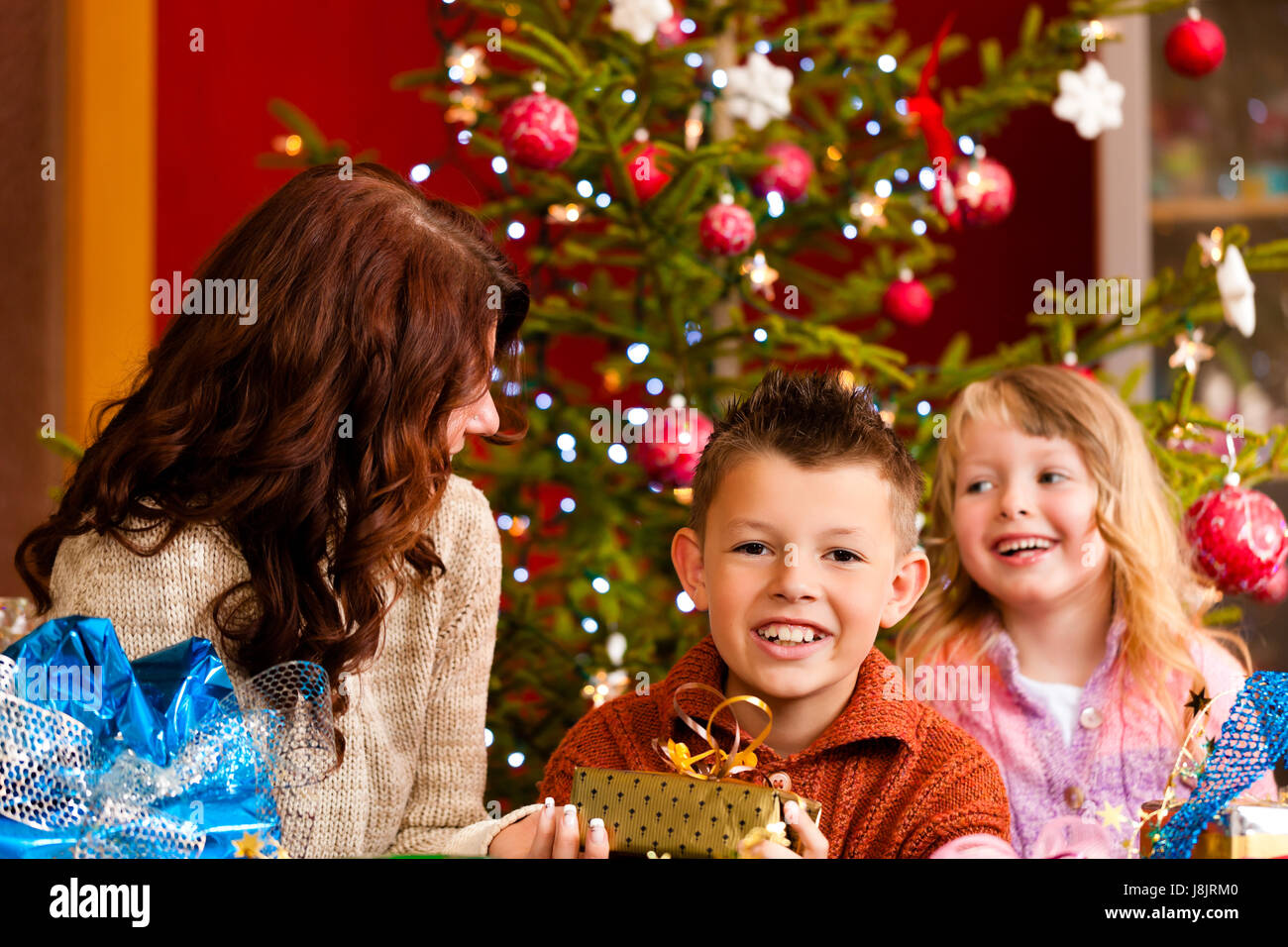 christmas family with gifts on christmas eve Stock Photo Alamy