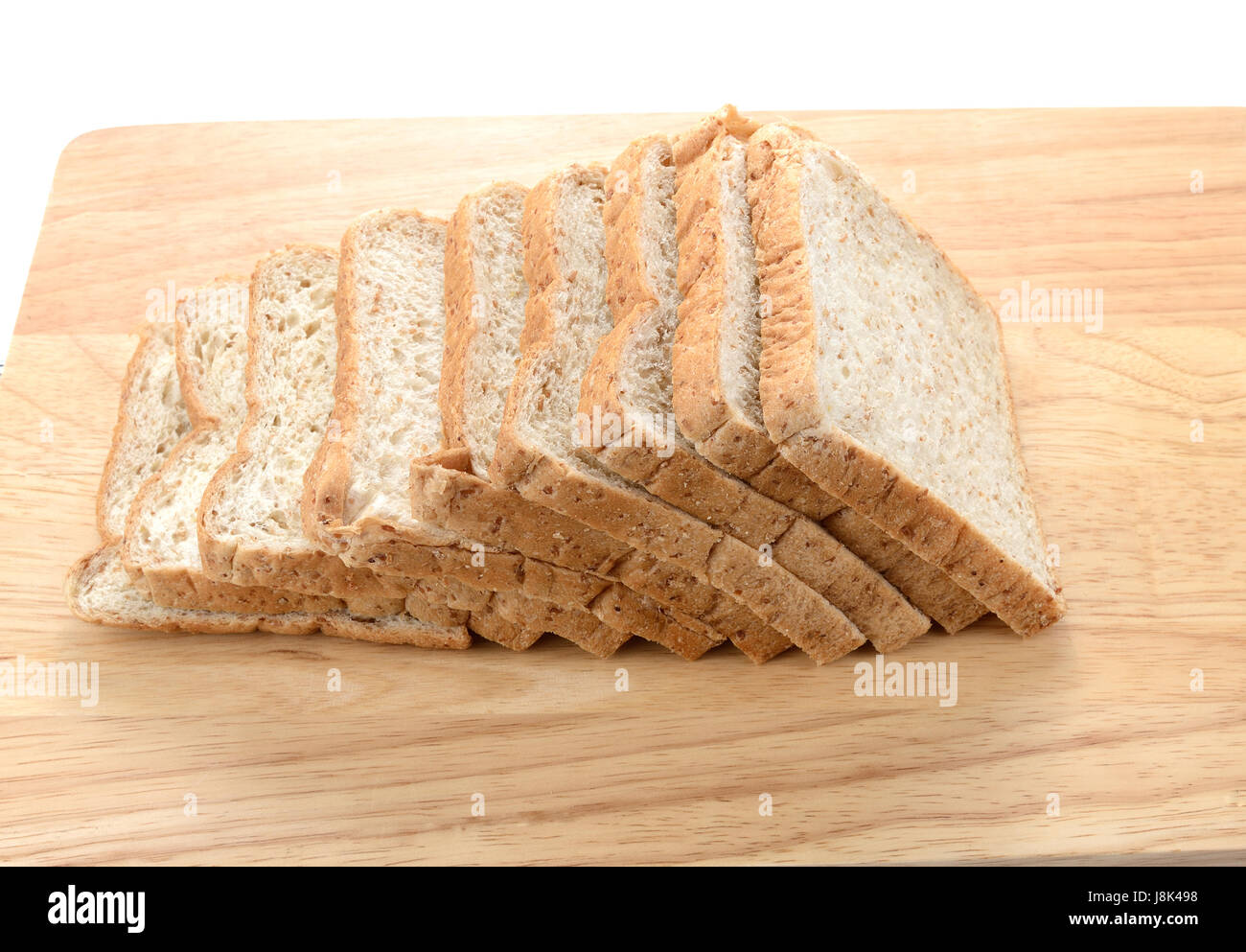 Slices of bran bread on wooden board isolated on white background Stock ...