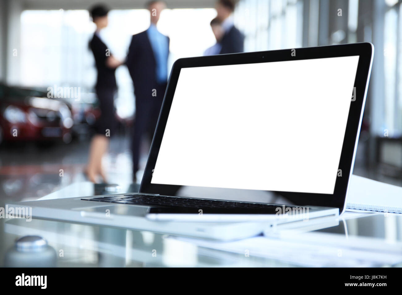 Laptop with blank screen on table in office Stock Photo - Alamy