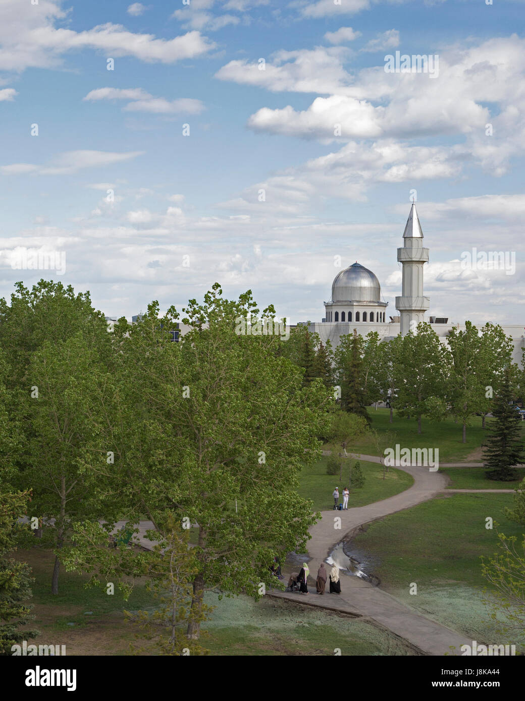 People walking through Prairie Winds Park towards Baitun Nur Mosque of