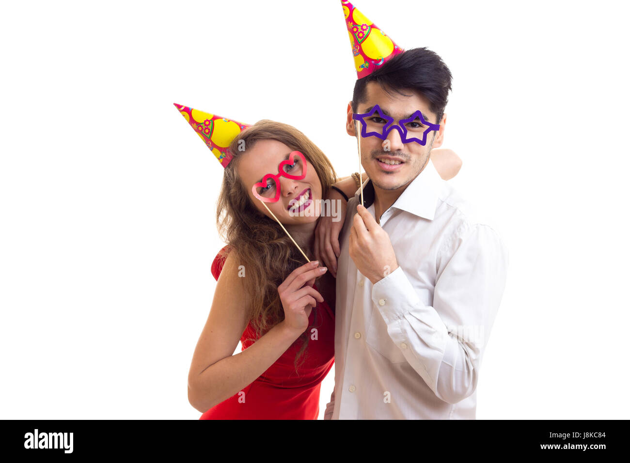 Young couple with card sticks and celebrating hats Stock Photo