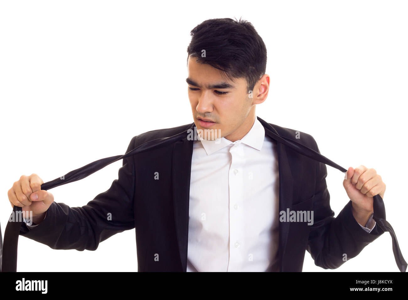 Young man in suit fixing his tie Stock Photo - Alamy